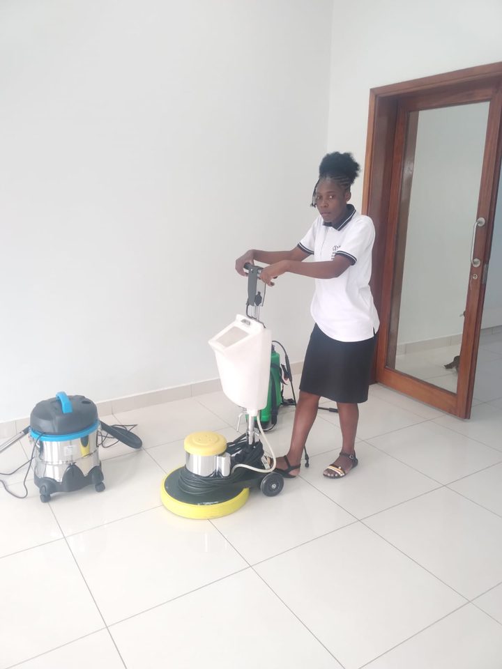 Horizon crew member polishing a tiled floor with a floor machine