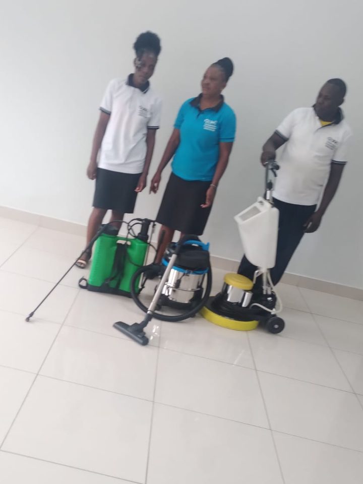 Three Horizon crew members in uniform with sprayer, vacuum and floor polisher